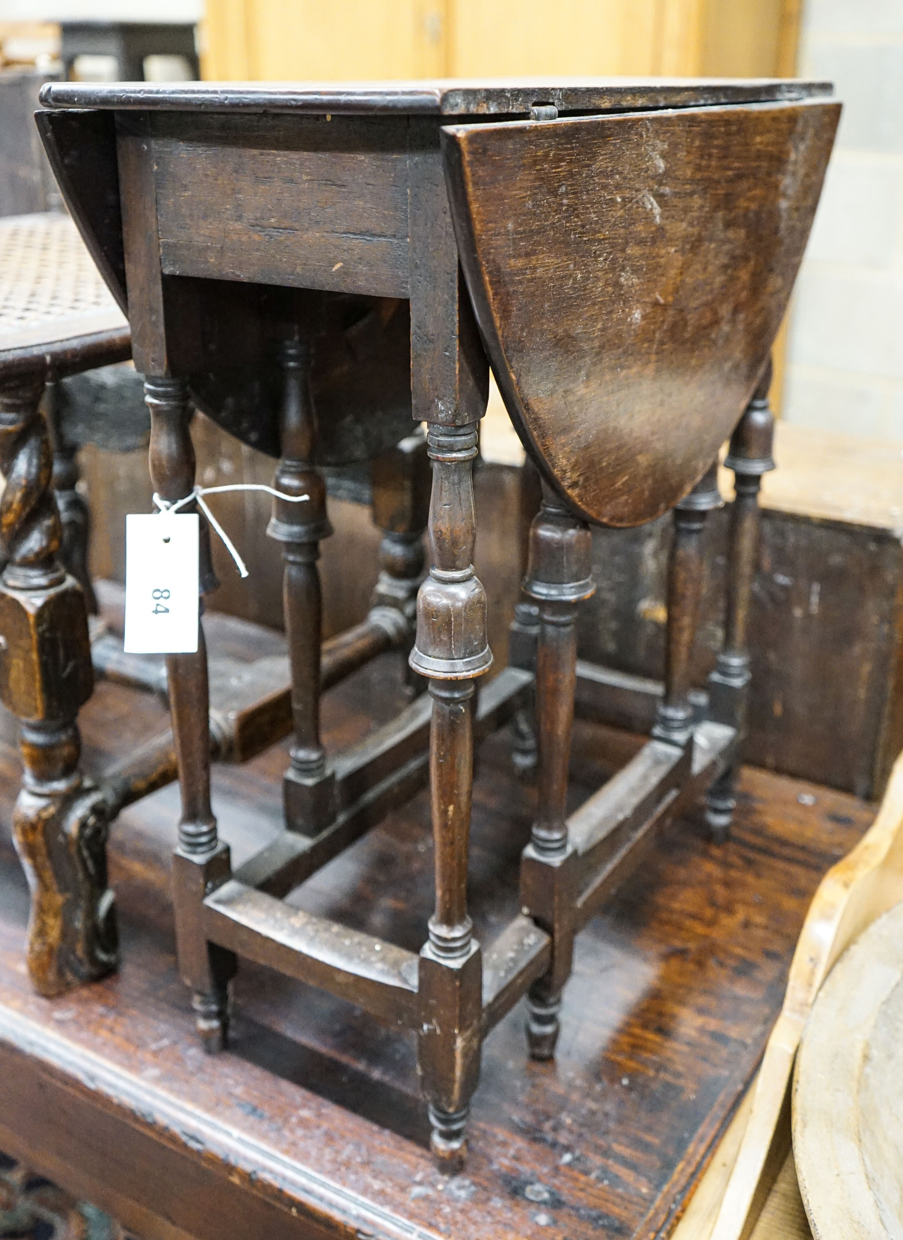 An unusually small late 17th century style mahogany gateleg table, with oval top and inverted cup turned legs, 65cm extended, depth 57cm, height 55cm